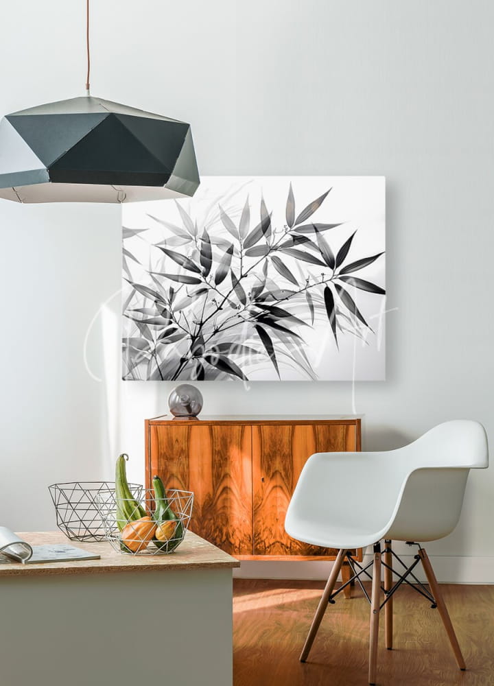 Black and white bamboo leaf canvas print hanging on wall showcasing minimalist nature art in monochrome style