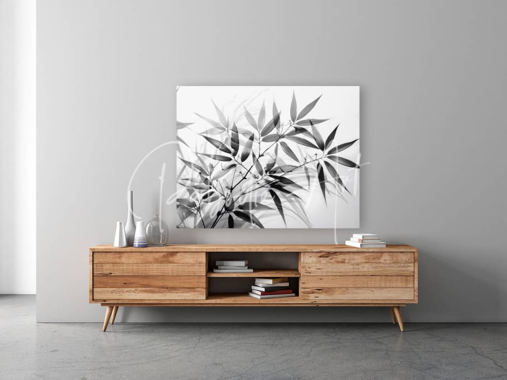 Black and white bamboo minimalist canvas print with leaf design mounted above wooden media console