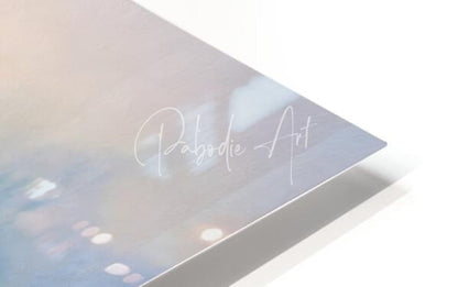A sleek translucent art print titled blue heron beachside with pastel blue and pink gradient and white cursive pabodie art text
