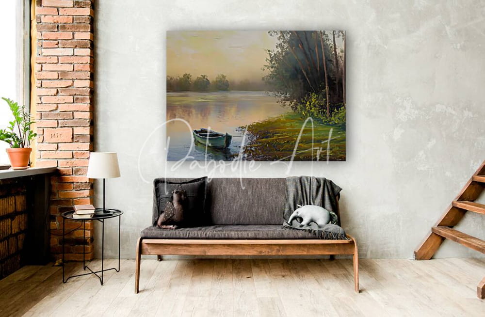 The boat along the bank painting depicts a serene landscape with a calm river, misty trees, and a green boat on a white wall