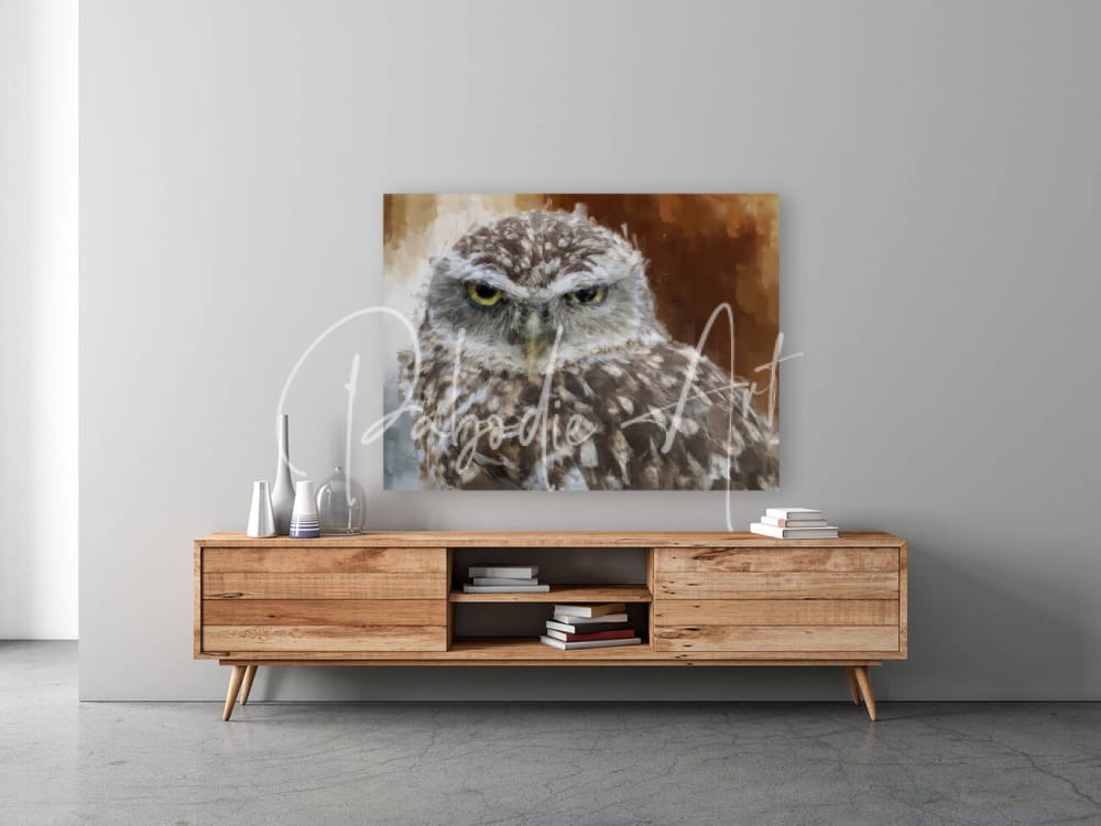 Burrowing owl portrait detailed canvas print of a speckled owl with yellow eyes in warm earthy tones on a wooden table