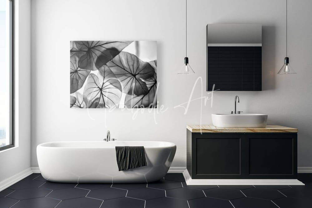 Black and white botanical canvas art featuring overlapping caladium leaf silhouettes for wall decor