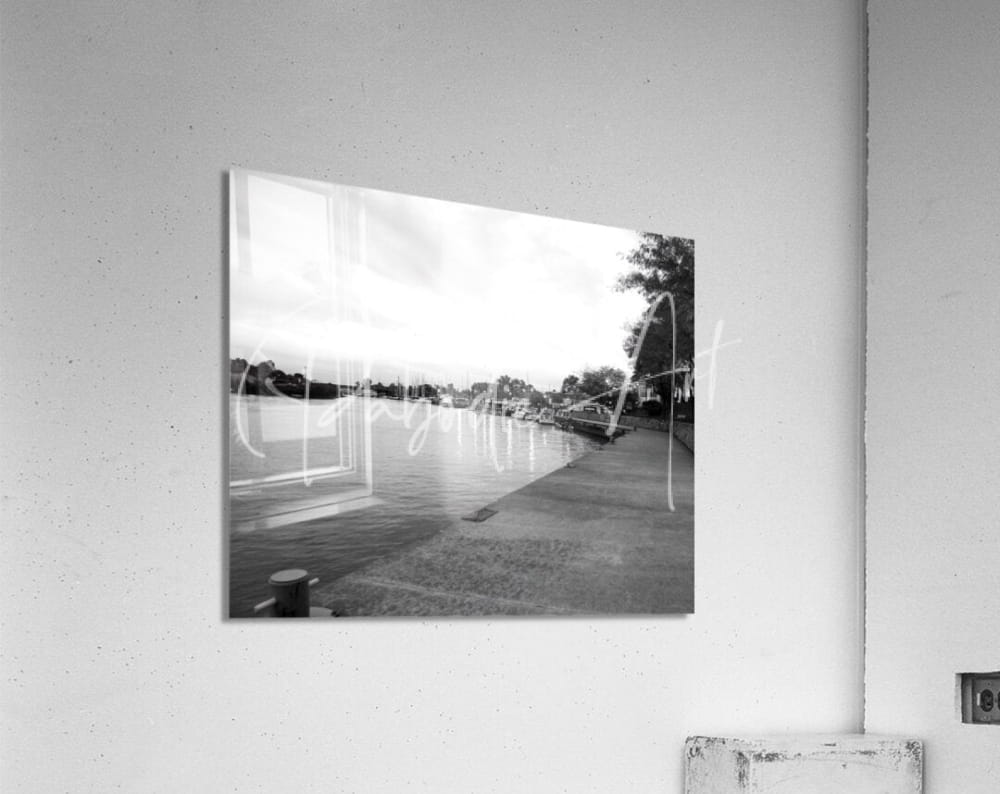 Black-and-white acrylic print of a riverside scene titled cloudy dawn mounted on a wall