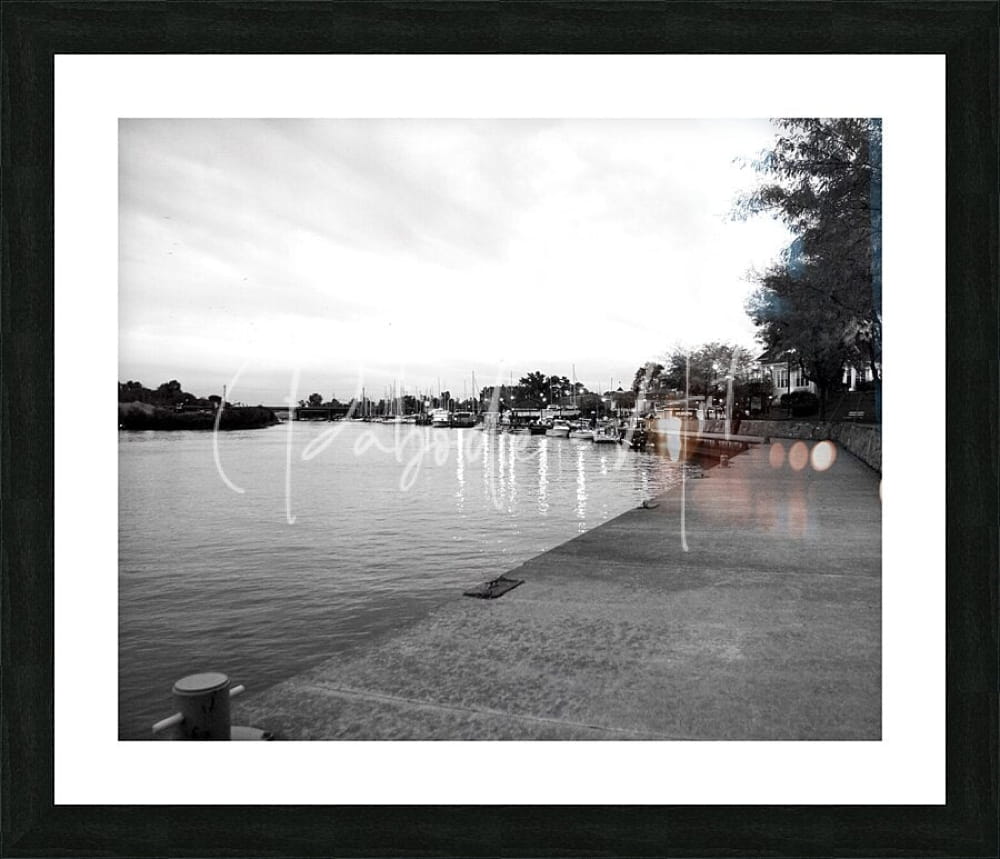 Black-framed black and white photograph of a cloudy dawn harbor scene for wall decor