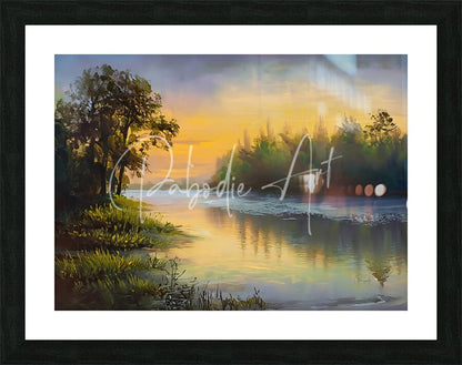 Framed landscape painting as the dawn breaks showing a serene sunset over water with golden hues and tree reflections