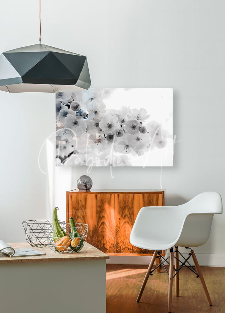 A modern white molded plastic chair with slender wooden legs inspired by delicate cherry blossoms design