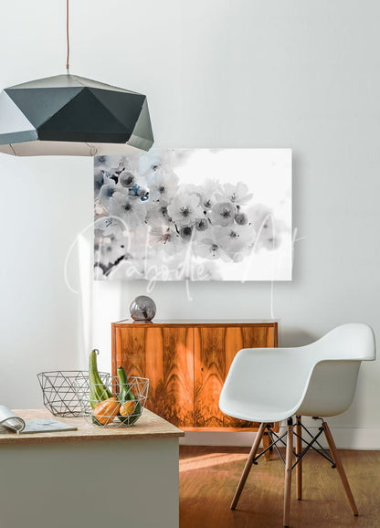 A modern white molded plastic chair with slender wooden legs inspired by delicate cherry blossoms design