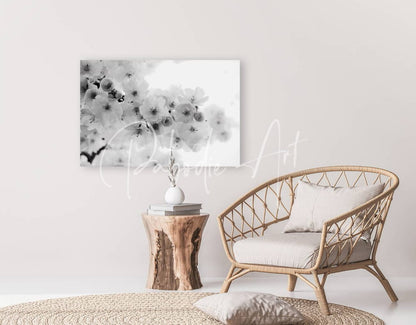 Black and white floral canvas art featuring delicate cherry blossoms hanging on a wall for home decor