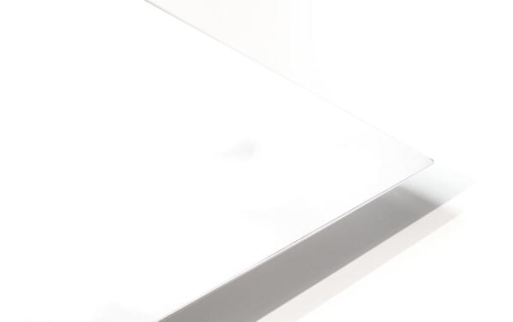 A sleek minimalist white laptop with glossy finish and rounded edges featured in delicate cherry blossoms design