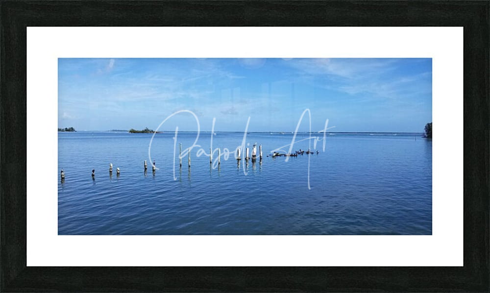 Black-framed art print dock of better days featuring a serene blue water scene with distant islands and wooden posts