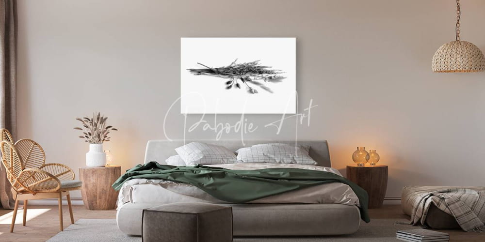 Black-and-white canvas print of a bundle of dried grasses and flower pods hanging on the wall