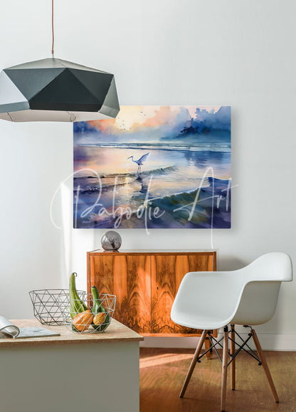 Watercolor painting of a white heron on wet sand at sunrise with blue and orange hues titled Egret Fishing