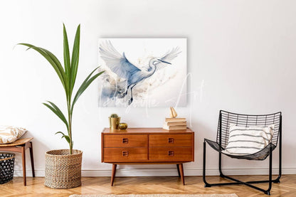 A serene watercolor painting of a white heron in mid-flight with soft blue and gray washes on white canvas