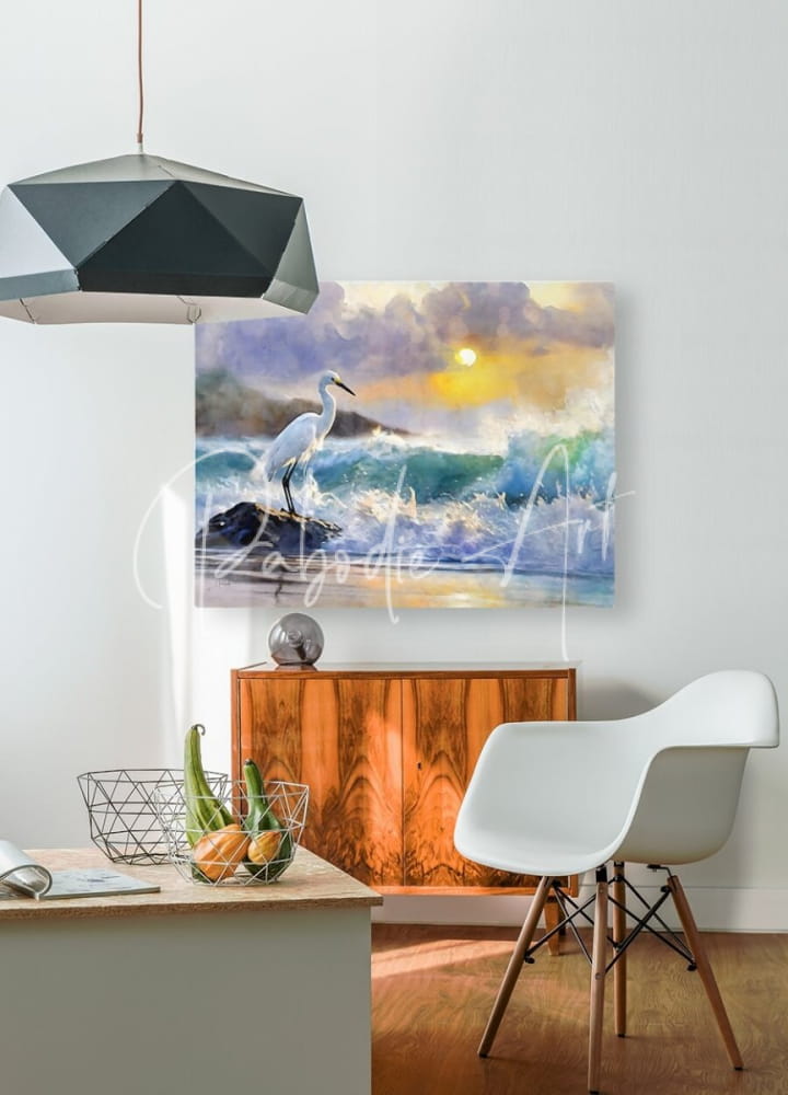 Watercolor painting of a white heron on rocks with ocean waves under a purple yellow and blue sunset sky titled the egret and the rough sea
