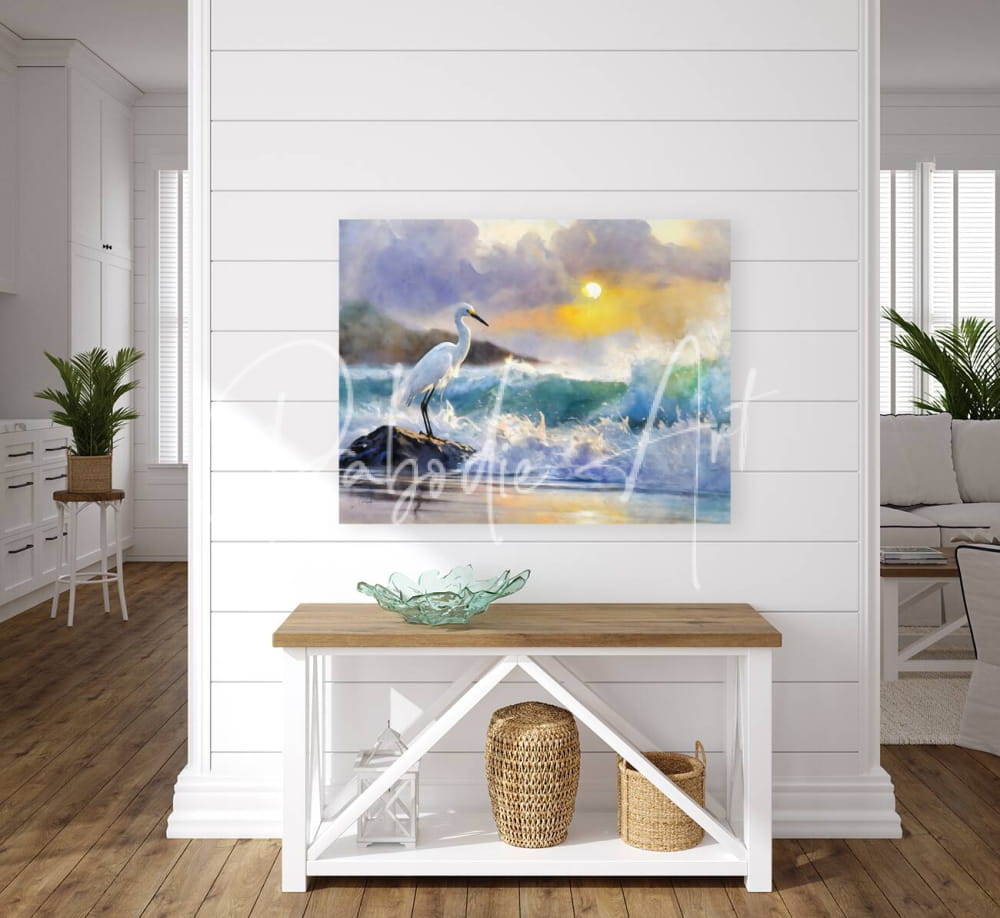 Watercolor painting of a white heron standing on rocks amid crashing ocean waves under a vibrant sunset sky