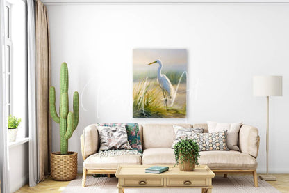 Egret by the sea is a serene white egret painting with soft brushstrokes hanging above a beige sofa in a minimalist room