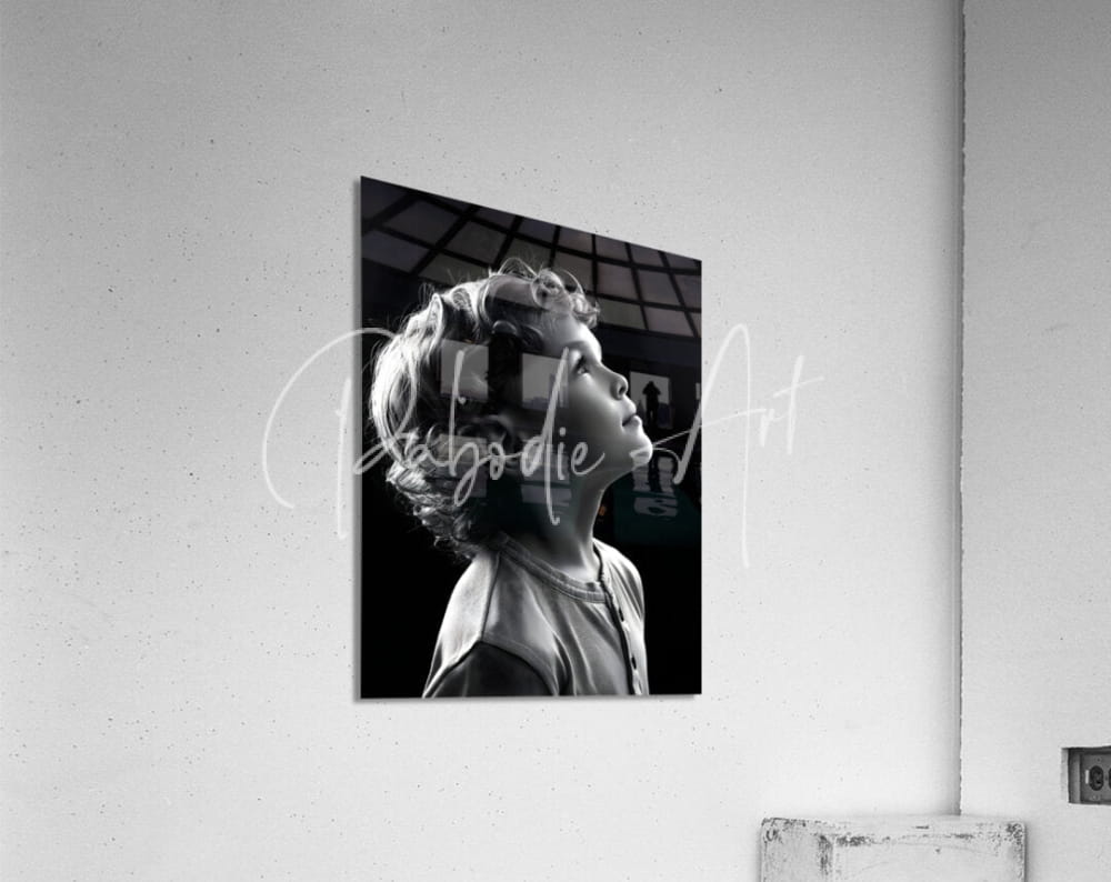 Black and white photographic print titled eyes to the sky of young child profile mounted on acrylic surface