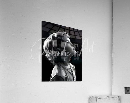 Black and white photographic print titled eyes to the sky of young child profile mounted on acrylic surface