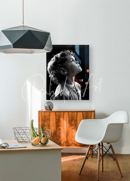 Black-and-white portrait print of a young boy with curly hair mounted on the wall from the eyes to the sky collection