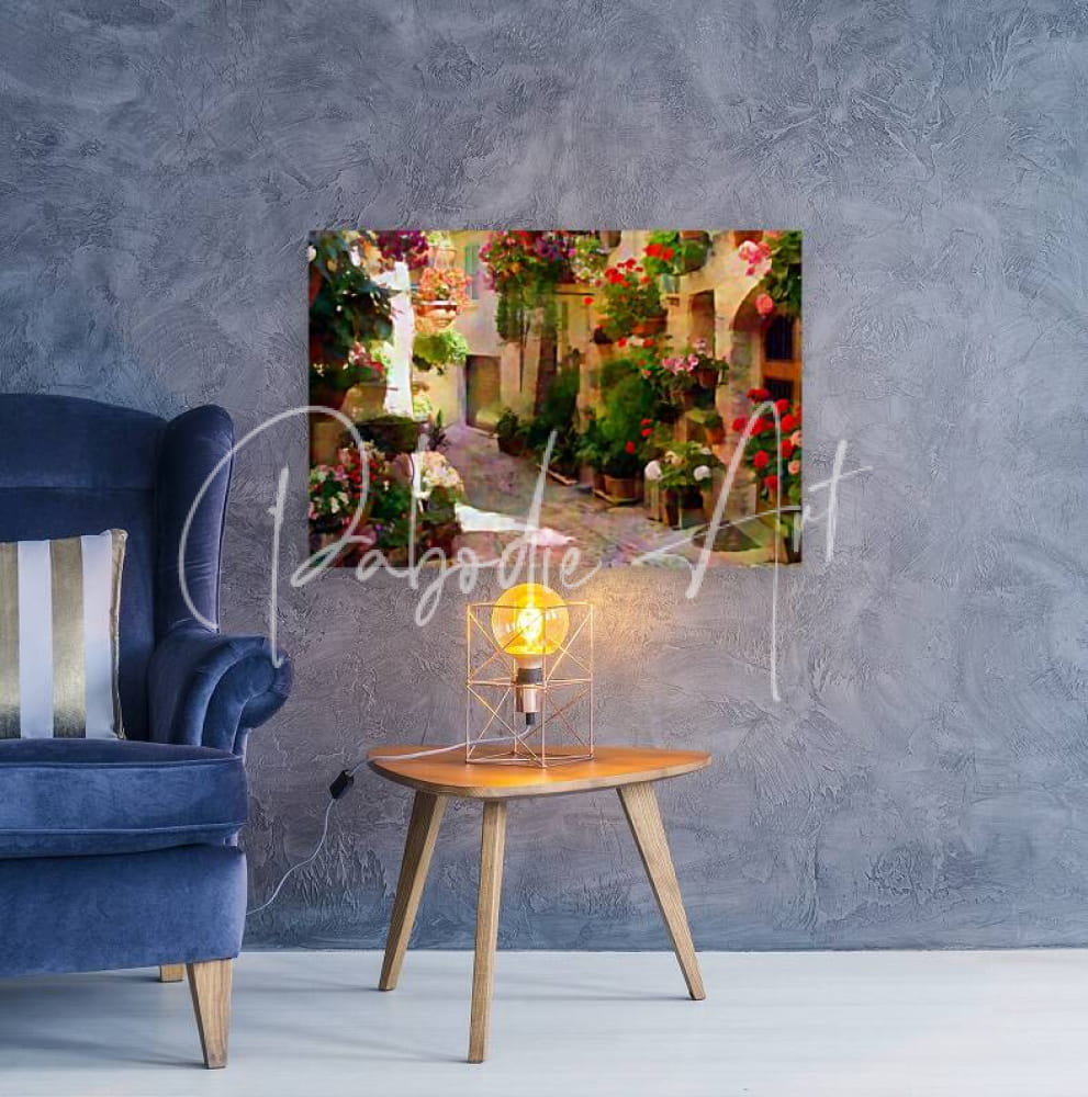 A vibrant rectangular canvas print of a sunlit european alleyway filled with colorful flowers on a gray wall