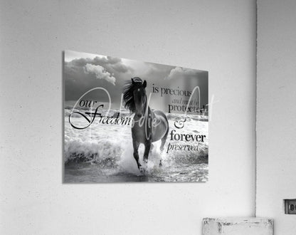 Black-and-white acrylic print of a galloping horse in ocean waves featuring elegant script text titled freedom horse