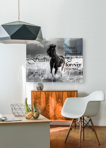 Framed canvas of a black horse running through water with inspirational text titled freedom horse for wall decor