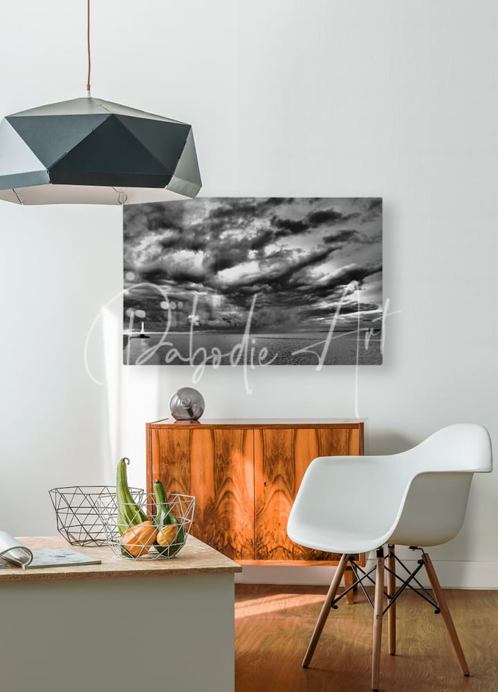 Black and white abstract cloudscape canvas print titled huron lighthouse incoming storm mounted on white wall