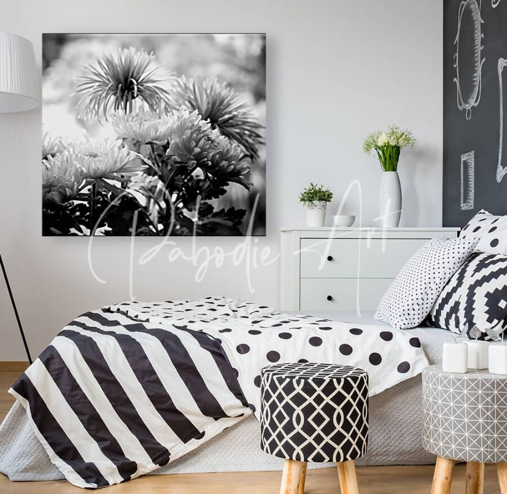Black-and-white floral canvas print titled mums and more in black and white hanging on the wall