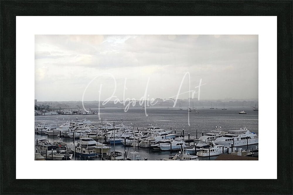 Black-framed art print of old port cove marina monochrome harbor scene with boats docked in calm waters under overcast sky