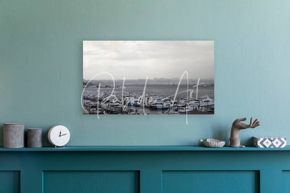 Black and white photograph of old port cove marina harbor with boats mounted on a teal wall