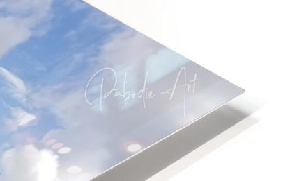 A sleek rectangular art print titled osprey reflections featuring a soft blue sky with white clouds and pabodie art signature