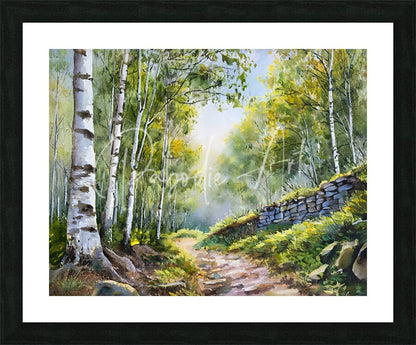 Framed watercolor painting titled path through the birches shows a sunlit forest path with birch trees and a stone wall