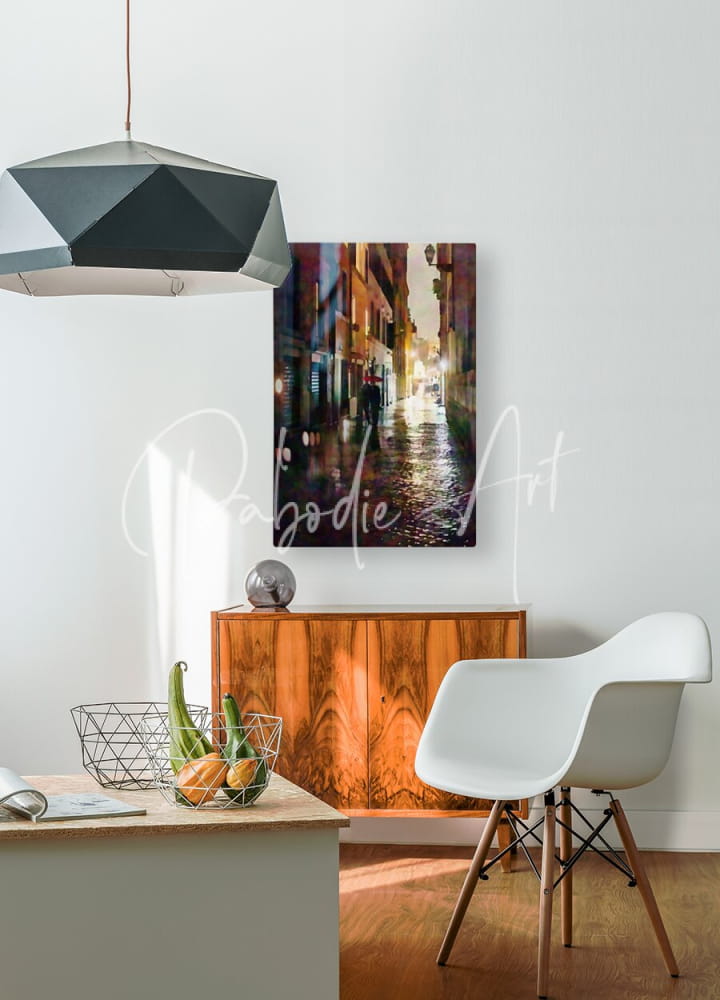 A rectangular canvas print titled rainy walk through a cobblestone alley featuring a vibrant street scene in golden and purple hues