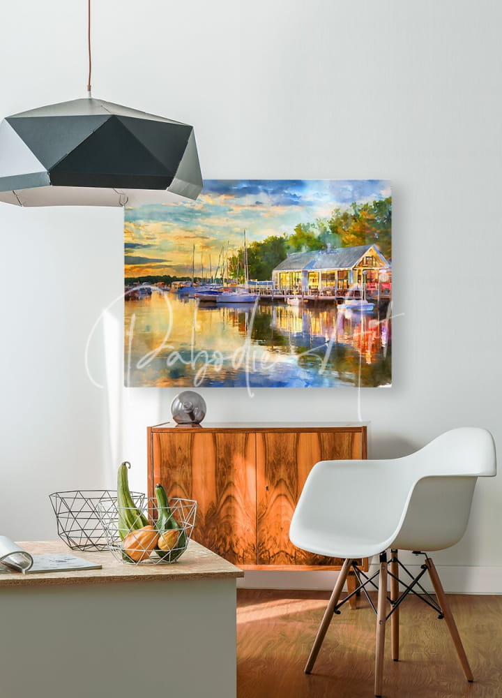 Watercolor painting of a harbor scene with boats and building displayed on a white wall for riverside dining in Vermilion