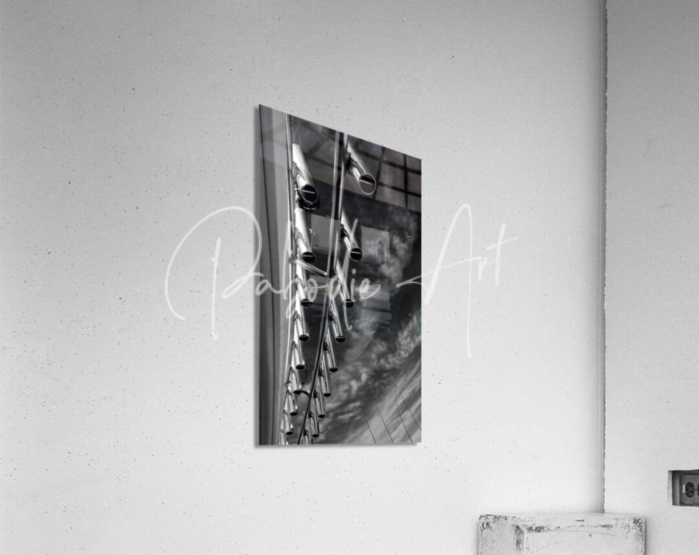 Black and white framed photograph of vertical industrial metal pipes used as rod holders in a minimalist design