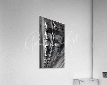 Black and white framed photograph of vertical industrial metal pipes used as rod holders in a minimalist design