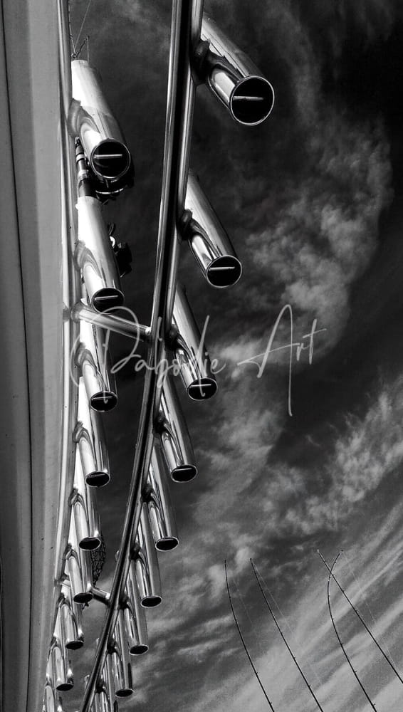 Shiny metallic rod holders with vertical tubes made of durable metal against a cloudy sky background