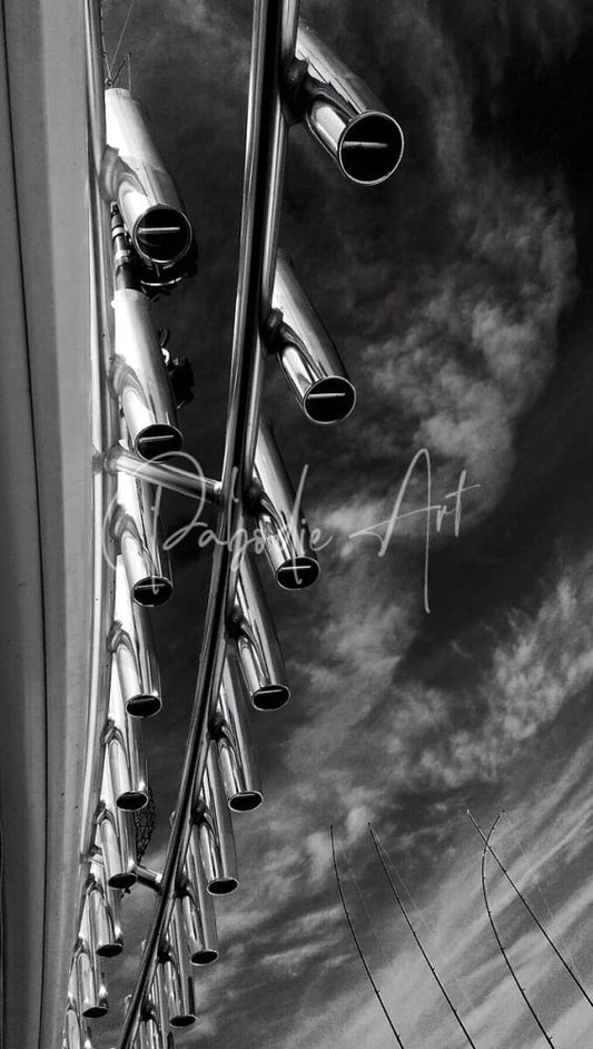 Shiny metallic silver rod holders made of durable metal tubes arranged vertically against a cloudy sky background