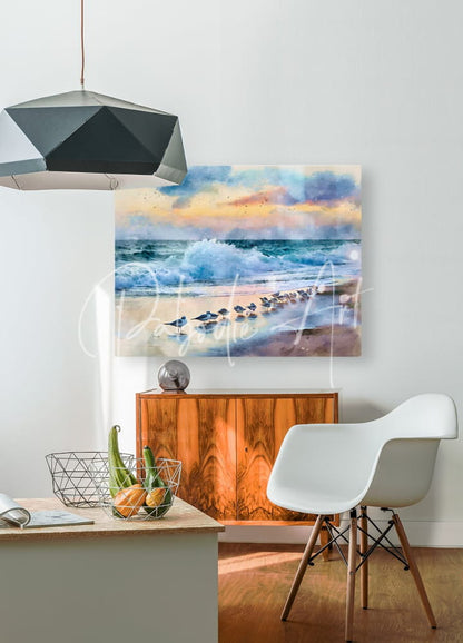 Watercolor painting titled sanderlings along the shore depicting a beach sunset with waves and birds on white wall