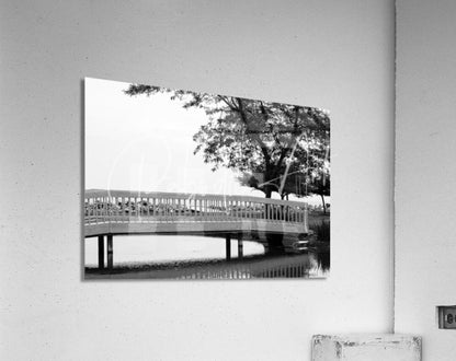 Black and white acrylic print of the sawmill creek wooden bridge with curved ornate railings over calm water
