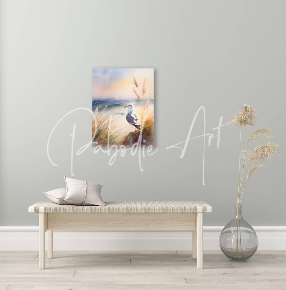 Watercolor painting of a seagull standing in tall grass against a soft sunset sky in seagull perch product
