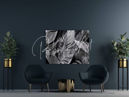 Black and white tropical leaf canvas art titled shades of night tropics i hanging on a dark wall