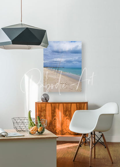 Beige canvas print of shorefishing featuring a turquoise ocean and cloudy sky beach scene for wall decor