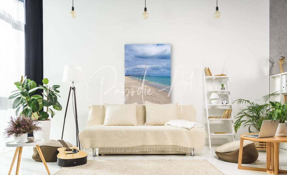 Beige textured sofa shorefishing with fringed throw blanket and matching cushions for cozy seating