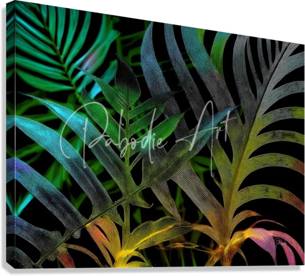 Vibrant tropical leaf canvas print with iridescent green teal yellow and pink hues on black background titled tropical leaves at night