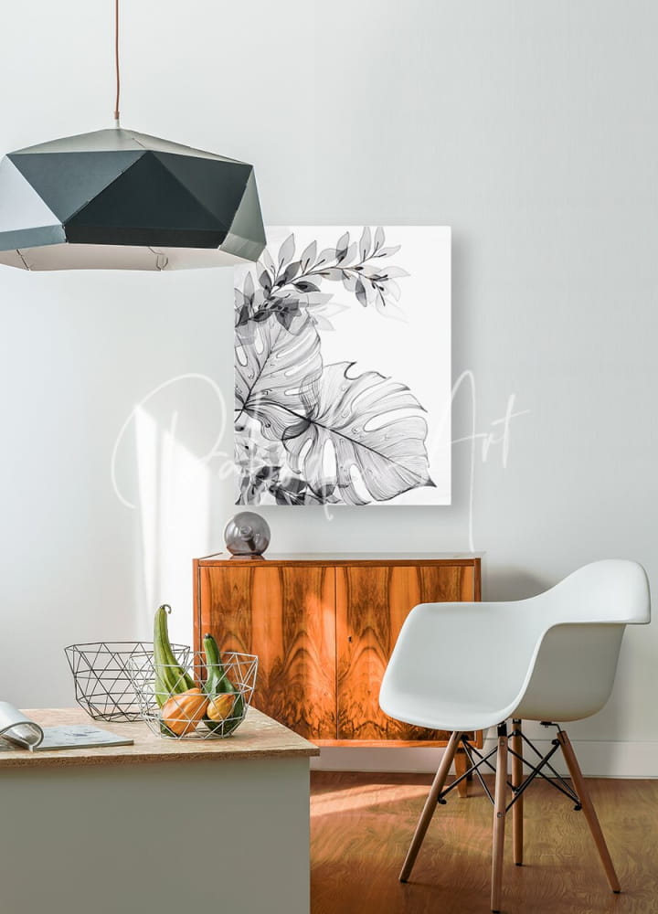 Black and white botanical canvas print featuring detailed monstera leaves titled tropical transparencies i