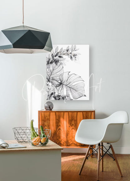 Black and white botanical canvas print featuring detailed monstera leaves titled tropical transparencies i