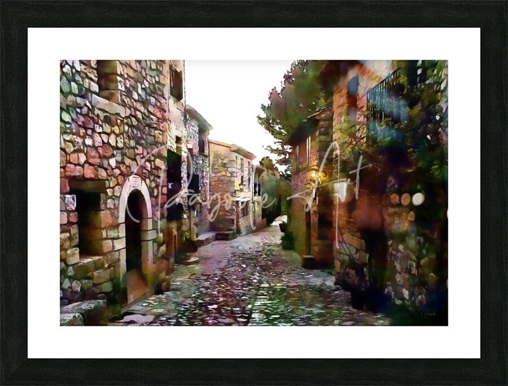 Black-framed art print of tuscany cobblestone streets and homes featuring rustic stone buildings and alleyway scene
