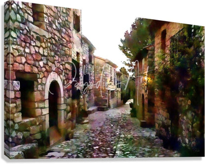 A rectangular canvas print featuring a painted scene of tuscany cobblestone streets and rustic stone homes in warm earth tones