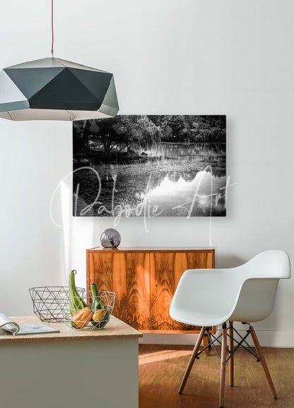 Black and white canvas print of a serene lake scene with weeping willows titled willow water reflections mounted on white wall